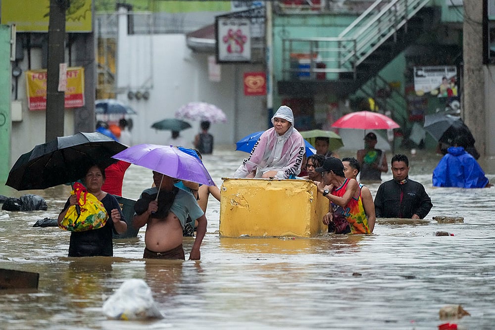 | Photo: AP/Aaron Favila : Philippines Tropical Storm Yagi: Flooded street caused by heavy rains in Cainta, Rizal province